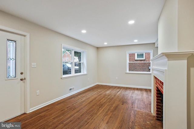 5210 57th Ave, Hyattsville, MD 20781 - unfurnished living room featuring a fireplace, wood finished floors, baseboards, and recessed lighting