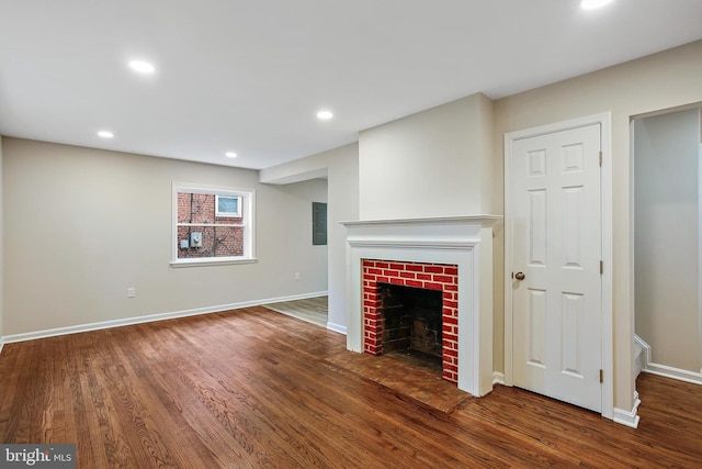 5210 57th Ave, Hyattsville, MD 20781 - unfurnished living room featuring wood finished floors, baseboards, a brick fireplace, and recessed lighting