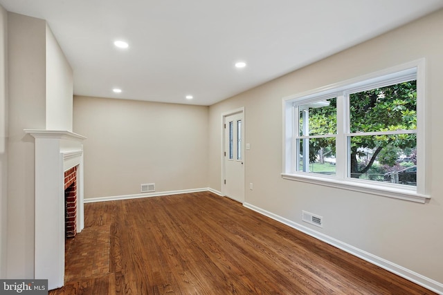 5210 57th Ave, Hyattsville, MD 20781 - unfurnished living room featuring baseboards, wood finished floors, recessed lighting, and a brick fireplace