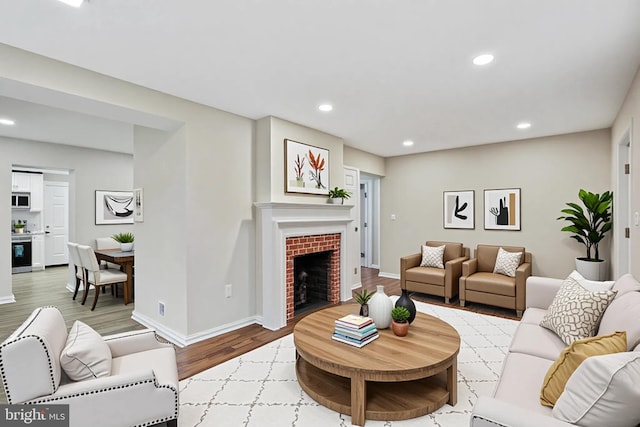 5210 57th Ave, Hyattsville, MD 20781 - living area featuring a tiled fireplace, recessed lighting, wood finished floors, and baseboards