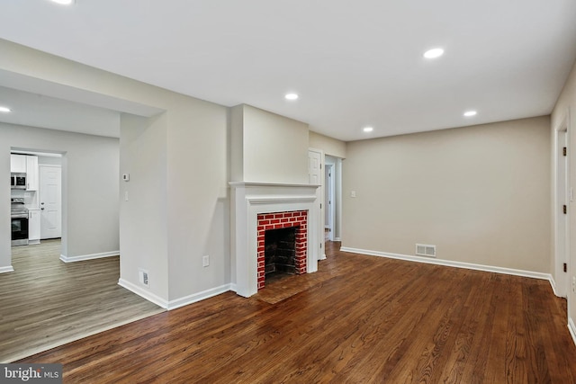5210 57th Ave, Hyattsville, MD 20781 - unfurnished living room with a fireplace, baseboards, wood finished floors, and recessed lighting