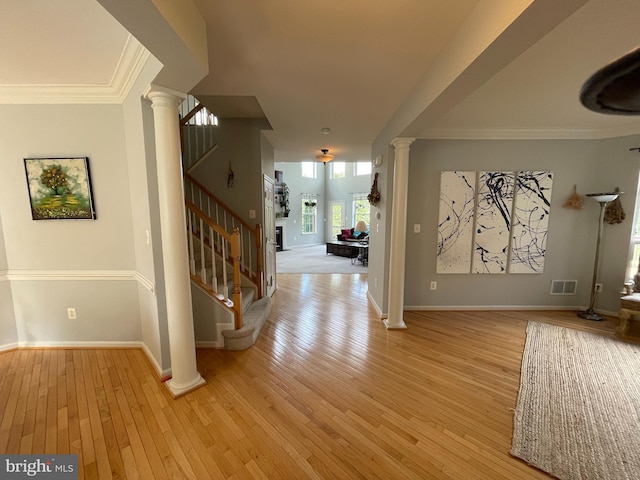 8341 Tillett Loop, Manassas, VA 20110 - entryway featuring decorative columns, light wood-type flooring, stairs, baseboards, and crown molding