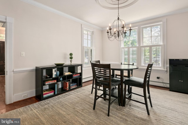 1704 N Royal Ave, Front Royal, VA 22630 - dining space featuring a baseboard radiator, crown molding, wood finished floors, and a chandelier
