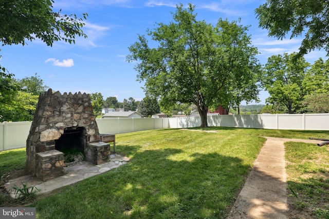 1704 N Royal Ave, Front Royal, VA 22630 - fenced backyard with an outdoor stone fireplace