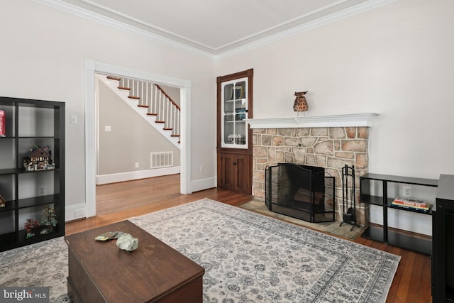 1704 N Royal Ave, Front Royal, VA 22630 - living area with wood finished floors, crown molding, stairway, and a fireplace