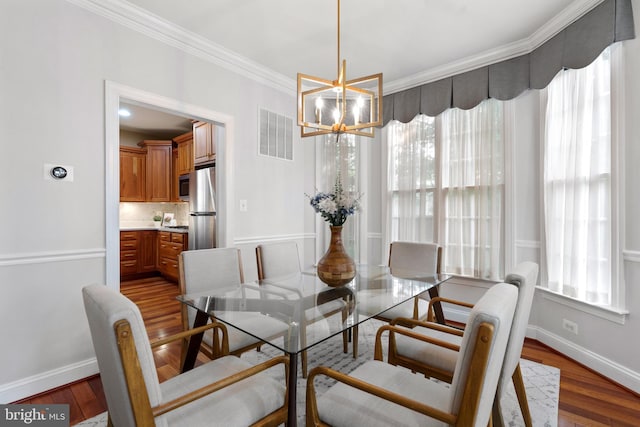 1318 S Kenmore Cir, Arlington, VA 22204 - dining area with ornamental molding, baseboards, a chandelier, and wood finished floors