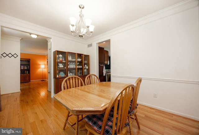3237 Walnut St, Downingtown, PA 19335 - dining area featuring a chandelier, light wood-style flooring, ornamental molding, and baseboards