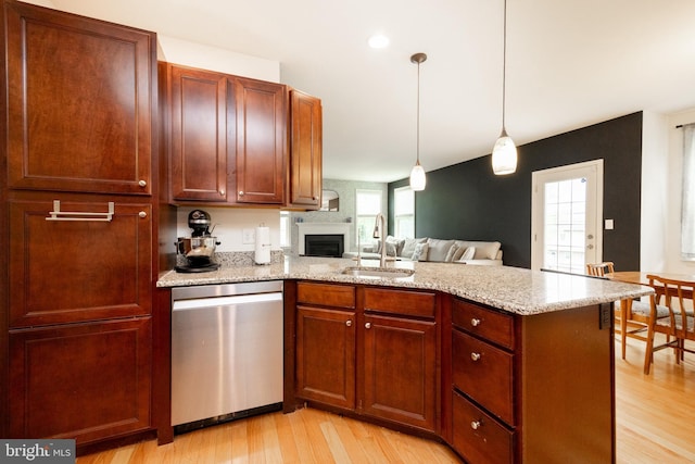 3237 Walnut St, Downingtown, PA 19335 - kitchen with dishwasher, a sink, a peninsula, light wood finished floors, and a fireplace