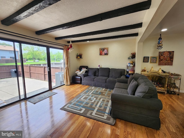 74 Probasco Rd, Hightstown, NJ 08520 - living area featuring wood finished floors, beamed ceiling, and a textured ceiling