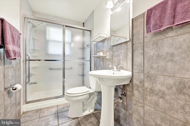15 Homberg Ave, Baltimore, MD 21221 - bathroom featuring tile walls, a shower stall, tile patterned flooring, and toilet