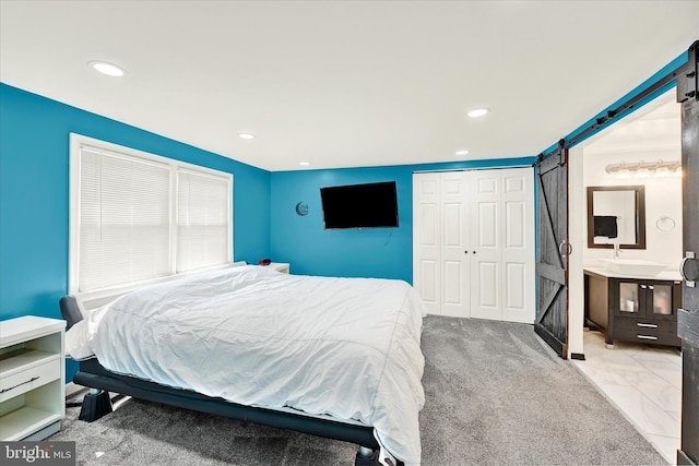 15 Homberg Ave, Baltimore, MD 21221 - bedroom with a barn door, a closet, recessed lighting, and a sink
