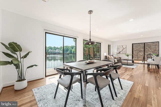 2127 Cabots Point Ln, Reston, VA 20191 - dining space featuring light wood-style flooring, recessed lighting, and a water view