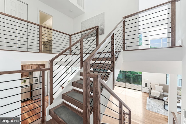 2127 Cabots Point Ln, Reston, VA 20191 - stairway with a high ceiling and wood finished floors