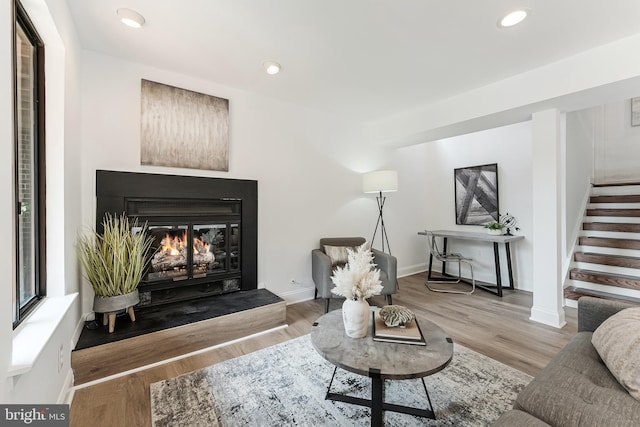 2127 Cabots Point Ln, Reston, VA 20191 - living area with stairway, a glass covered fireplace, wood finished floors, and recessed lighting