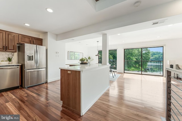 2127 Cabots Point Ln, Reston, VA 20191 - kitchen featuring appliances with stainless steel finishes, dark wood-type flooring, healthy amount of natural light, light countertops, and recessed lighting