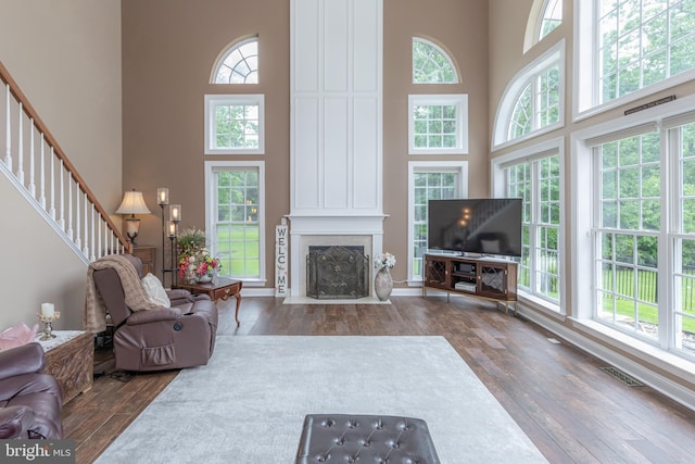 11 Harvest Dr, Pittsgrove, NJ 08318 - living room with a high ceiling, hardwood / wood-style floors, stairway, a fireplace with flush hearth, and baseboards