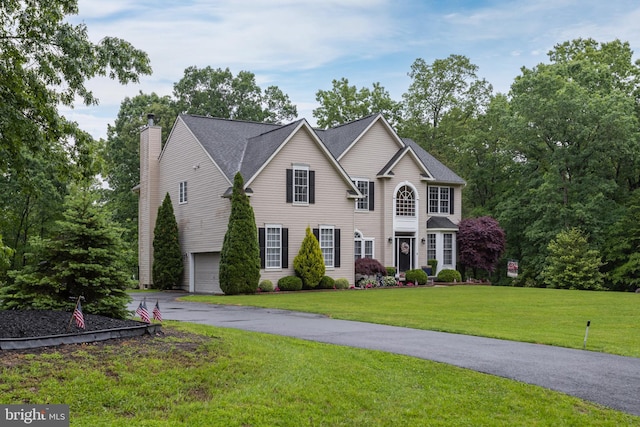 11 Harvest Dr, Pittsgrove, NJ 08318 - view of front of home featuring a chimney, an attached garage, a front lawn, and driveway