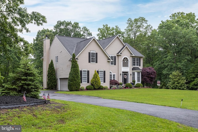 11 Harvest Dr, Pittsgrove, NJ 08318 - view of front of property featuring a chimney, a garage, asphalt driveway, and a front lawn