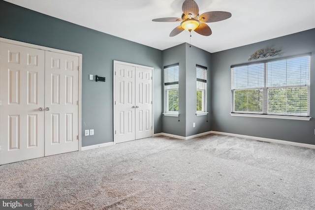 16758 Blackjack Oak Ln, Woodbridge, VA 22191 - unfurnished bedroom featuring two closets, carpet, baseboards, and ceiling fan