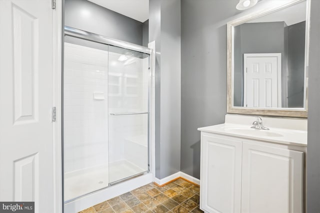 16758 Blackjack Oak Ln, Woodbridge, VA 22191 - bathroom featuring a shower stall, vanity, baseboards, and stone finish flooring