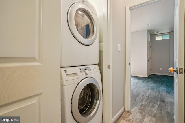 16758 Blackjack Oak Ln, Woodbridge, VA 22191 - laundry room with estacked washer and dryer, baseboards, and wood finished floors