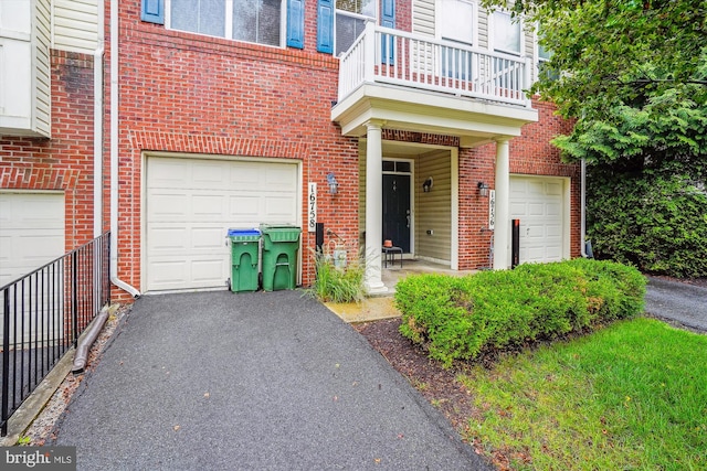 16758 Blackjack Oak Ln, Woodbridge, VA 22191 - view of exterior entry featuring a garage, a balcony, and brick siding