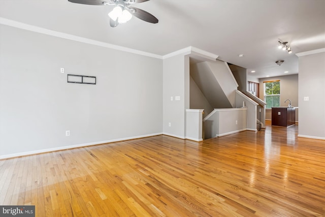 16758 Blackjack Oak Ln, Woodbridge, VA 22191 - unfurnished living room featuring light wood finished floors, ceiling fan, crown molding, and baseboards