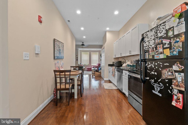 2740 Saint Paul St, Baltimore, MD 21218 - kitchen with appliances with stainless steel finishes, white cabinetry, a ceiling fan, wood finished floors, and recessed lighting