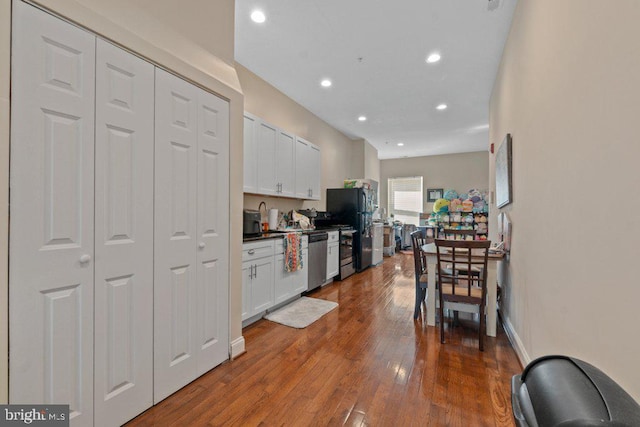 2740 Saint Paul St, Baltimore, MD 21218 - kitchen with freestanding refrigerator, white cabinets, stainless steel dishwasher, recessed lighting, and dark wood-style floors