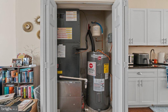 2740 Saint Paul St, Baltimore, MD 21218 - utility room with water heater and a sink