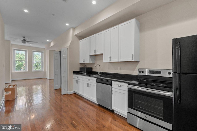 2740 Saint Paul St, Baltimore, MD 21218 - kitchen featuring stainless steel appliances, a sink, dark countertops, white cabinets, and recessed lighting