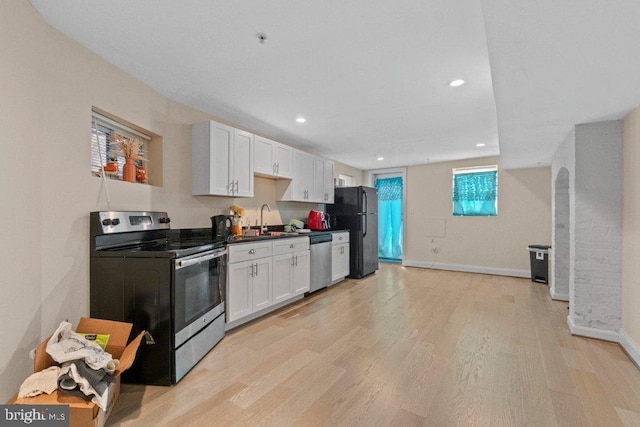 2740 Saint Paul St, Baltimore, MD 21218 - kitchen with stainless steel appliances, white cabinetry, light wood-style floors, baseboards, and recessed lighting