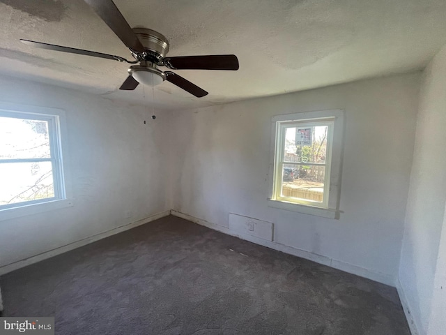 29 Church St, Bridgeton, NJ 08302 - spare room featuring plenty of natural light, dark colored carpet, a textured ceiling, and baseboards