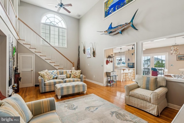 461 Anchor Rd, Tuckerton, NJ 08087 - living area featuring a ceiling fan, plenty of natural light, wood finished floors, stairs, and high vaulted ceiling