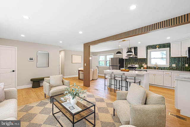 12300 La Plata St, Silver Spring, MD 20904 - living room featuring plenty of natural light, baseboards, light wood-style floors, and recessed lighting