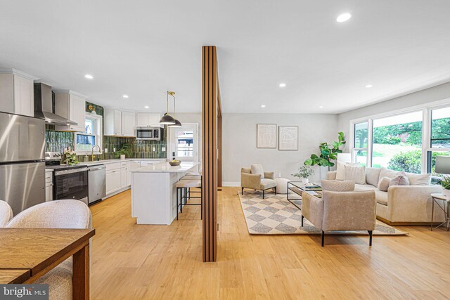 12300 La Plata St, Silver Spring, MD 20904 - living area featuring healthy amount of natural light, light wood-style floors, recessed lighting, and baseboards