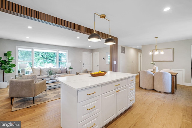 12300 La Plata St, Silver Spring, MD 20904 - kitchen with open floor plan, light wood-style flooring, white cabinetry, a kitchen island, and recessed lighting