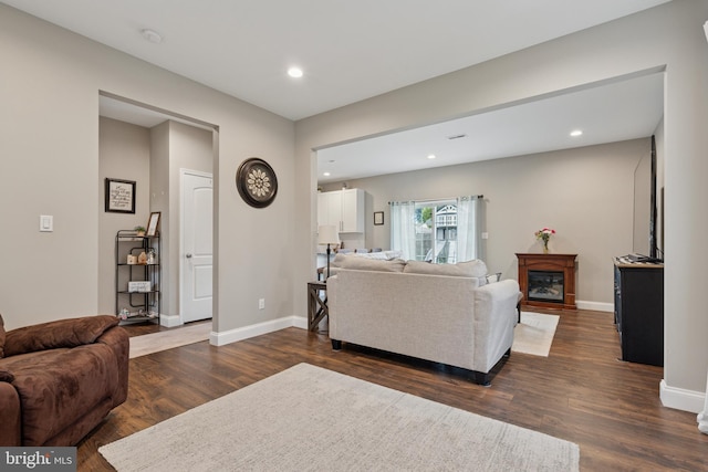 120 Northturn Ln, Levittown, PA 19054 - living area featuring dark wood-type flooring, recessed lighting, baseboards, and a glass covered fireplace