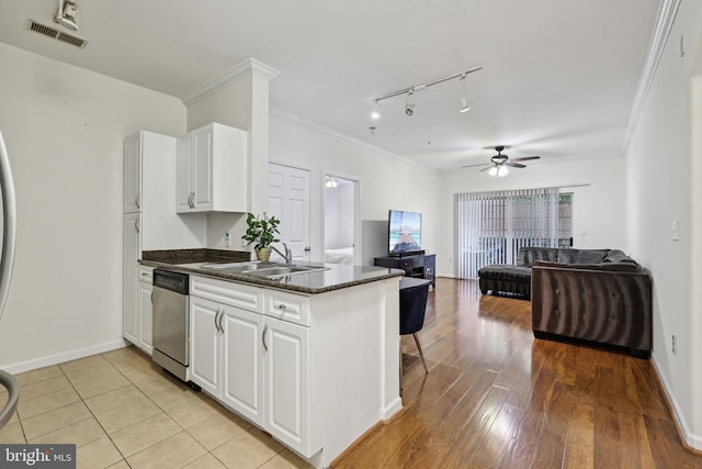 12925 Centre Park Cir Unit 106, Herndon, VA 20171 - kitchen with a sink, stainless steel dishwasher, open floor plan, white cabinetry, and ornamental molding