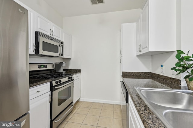 12925 Centre Park Cir Unit 106, Herndon, VA 20171 - kitchen with stainless steel appliances, white cabinets, baseboards, and light tile patterned floors
