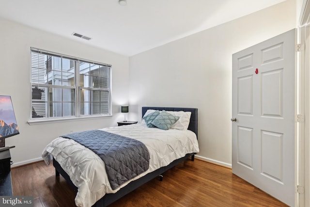 12925 Centre Park Cir Unit 106, Herndon, VA 20171 - bedroom featuring baseboards and wood finished floors