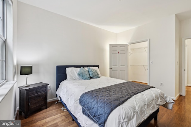 12925 Centre Park Cir Unit 106, Herndon, VA 20171 - bedroom with wood finished floors, baseboards, a spacious closet, and a closet