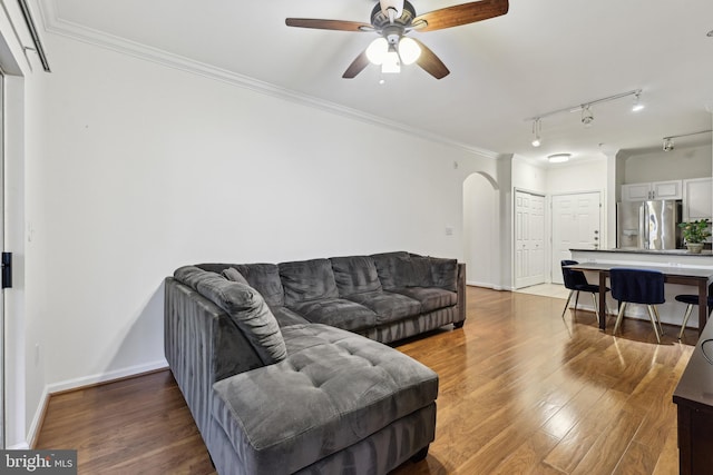 12925 Centre Park Cir Unit 106, Herndon, VA 20171 - living room featuring arched walkways, wood finished floors, ceiling fan, ornamental molding, and baseboards
