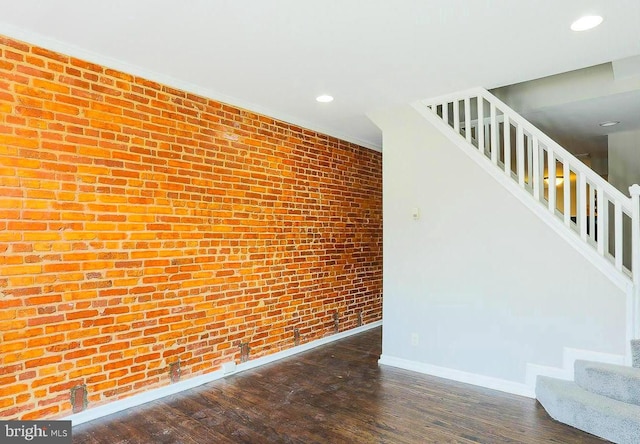 1114 W Cross St, Baltimore, MD 21230 - unfurnished living room with stairway, recessed lighting, dark wood-style flooring, and brick wall