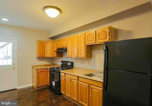 1114 W Cross St, Baltimore, MD 21230 - kitchen with black appliances, under cabinet range hood, light countertops, dark wood-style floors, and recessed lighting