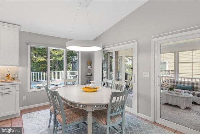 917 Lake View Dr, Bethany Beach, DE 19930 - dining room with healthy amount of natural light, vaulted ceiling, light tile patterned flooring, and baseboards