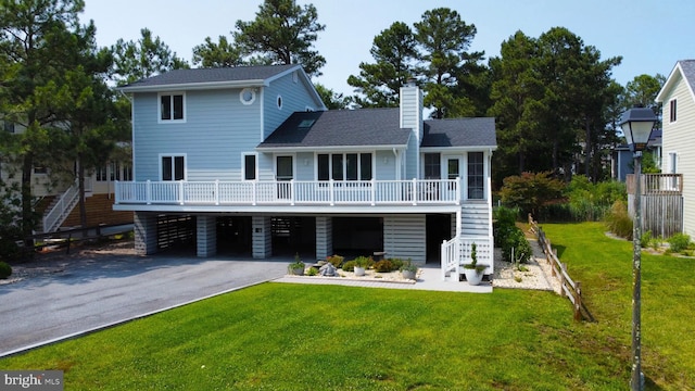 917 Lake View Dr, Bethany Beach, DE 19930 - rear view of house featuring stairs, asphalt driveway, a carport, a chimney, and a yard