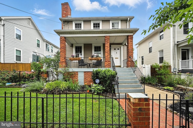 3921 22nd St NE, Washington, DC 20018 - view of front of home with a porch, a chimney, a fenced front yard, and brick siding