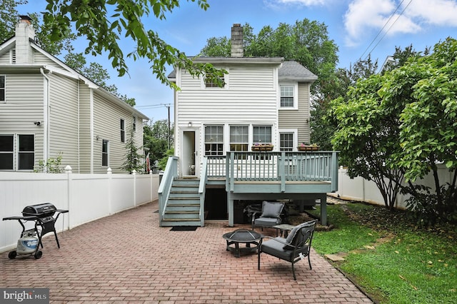 3921 22nd St NE, Washington, DC 20018 - back of property with a fire pit, a patio, a deck, a fenced backyard, and stairs