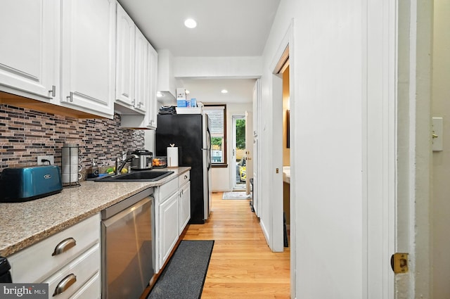 3921 22nd St NE, Washington, DC 20018 - kitchen featuring stainless steel appliances, tasteful backsplash, light wood-style flooring, white cabinets, and recessed lighting